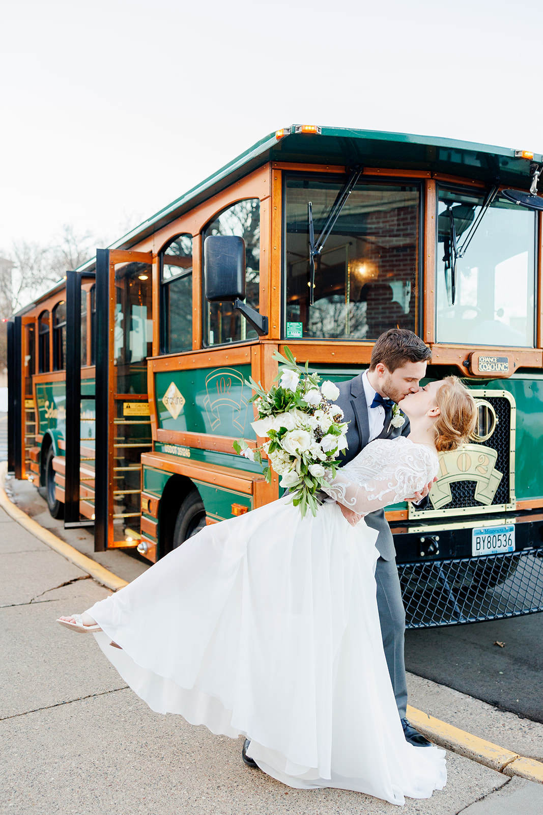 Bride and groom kisses in front of a trolley