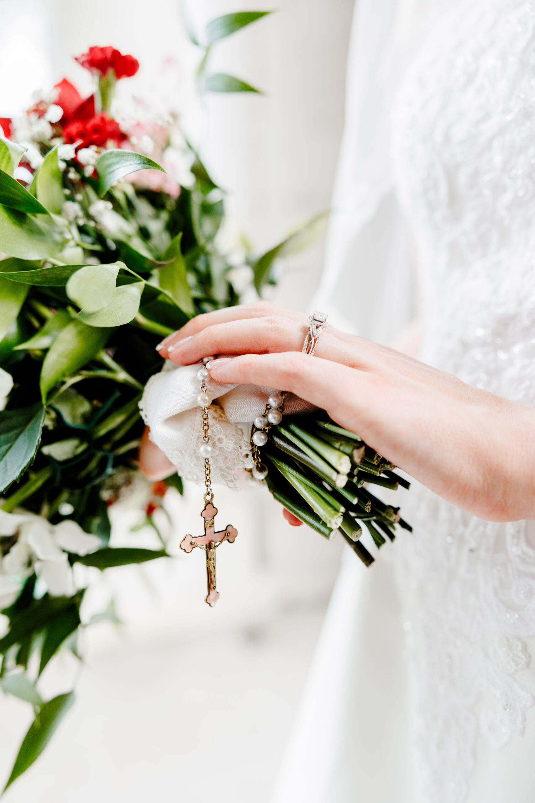 Rosary wrapped around a bride's wedding bouquet